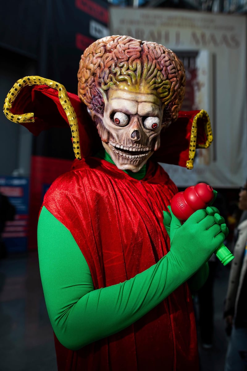 An attendee dressed as a Martian from 'Mars Attacks!' poses during New York Comic Con. AP