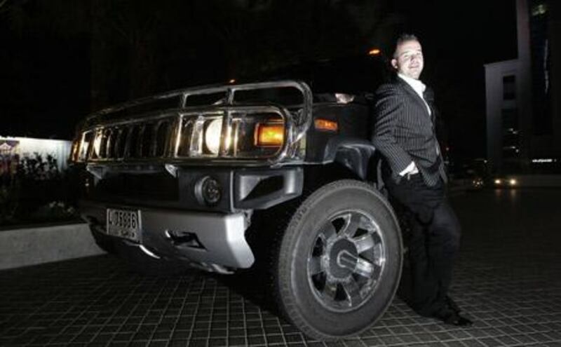 Sebastien Noat poses beside his Hummer H2, a purchase inspired by a Hollywood encounter. ?I love cars that look mean, that look a bit gangster?.