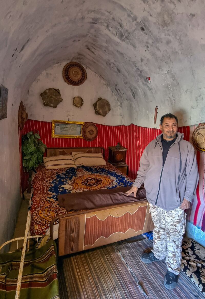 A damous resident stands in a bedroom
