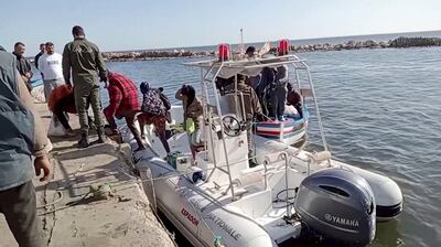 Tunisian coast guard helps migrants disembark from rescue boat in Sfax. Reuters