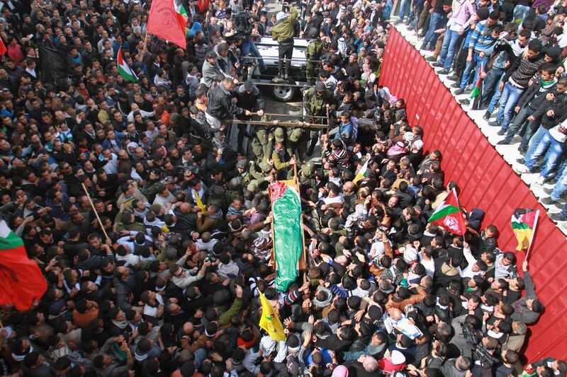 Palestinians attend the funeral of Arafat Jaradat in the West Bank town of Saeer, near Hebron, Monday, Feb. 25, 2013. Thousands have attended the funeral procession of a 30-year-old Palestinian man who died under disputed circumstances in Israeli custody. Palestinian officials say autopsy results show Jaradat was tortured by Israeli interrogators, while Israeli officials say there's no conclusive cause of death yet and that more tests are needed. (AP Photo/Nasser Shiyoukhi) *** Local Caption ***  Mideast Israel Palestinians.JPEG-06e6a.jpg