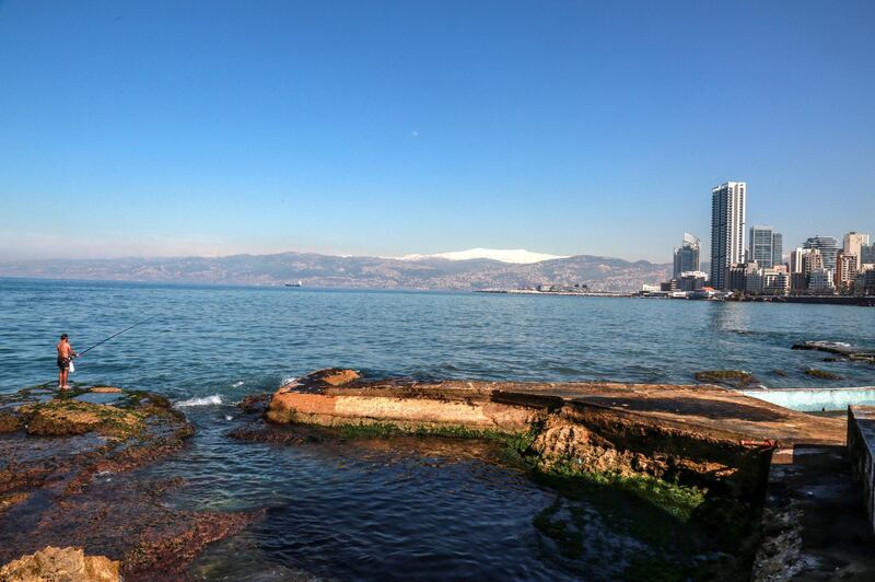epa08269902 A man fishes during a sunny day on the Mediterranean shore in Beirut, Lebanon, 04 March 2020. Lebanon is facing a financial crisis after months of political instability as the International Monetary Fund (IMF) has estimated public debt to record 155 percent of the GDP by the end of 2019.  EPA/NABIL MOUNZER