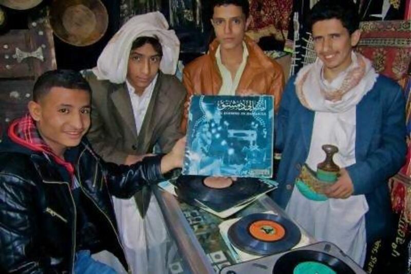 Young men holding vintage records in a shop in Yemen. Chris Menist was struck by the helpfulness of people in Sanaa and Aden, once they understood what he was looking for.