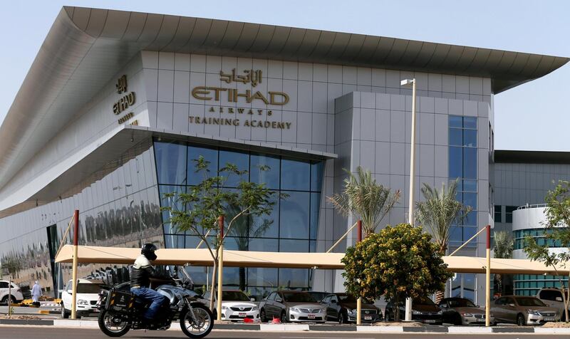 A motorist drives past the Etihad Airways Training Academy in Abu Dhabi on March 13, 2014. Etihad and Alitalia have been in talks for weeks on a possible investment by the Gulf carrier, which sources close to the matter say could involve Etihad buying a 40 percent stake in Alitalia for as much as 300 million euros ($404.6 million). AFP PHOTO/KARIM SAHIB (Photo by KARIM SAHIB / AFP)