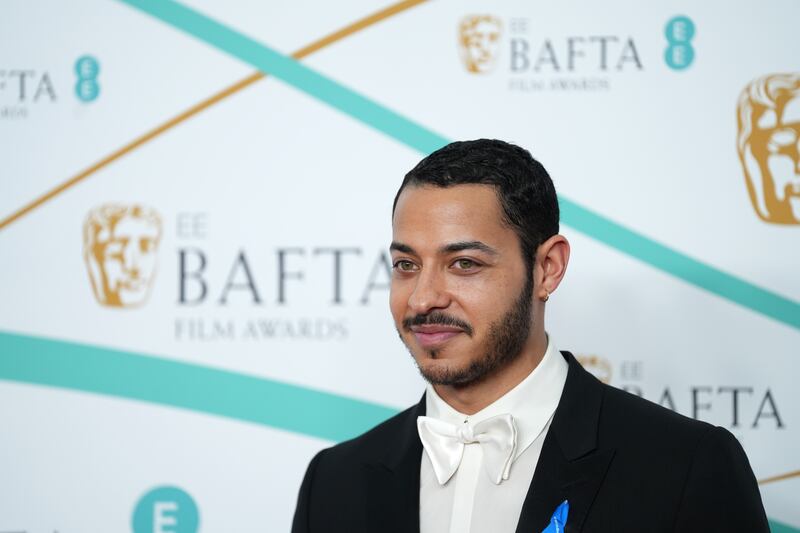 Actor Daryl McCormack wears his #WithRefugees blue ribbon at the Baftas. Getty 