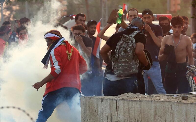 Iraqi security forces fire tear gas during ongoing anti-government protests in Basra. AP Photo