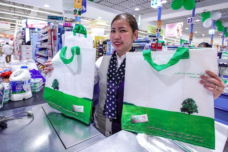 Abu Dhabi, United Arab Emirates, March 10, 2020. Lulu Hypermarket going plastic bag free and cleanliness-conscious to combat the Covid-19 outbreak.  Cashier, Julie Ann, with some reusable grocery bags for sale for AED 2.50.Victor Besa / The NationalSection:  NAReporter:  Haneen Dajani
