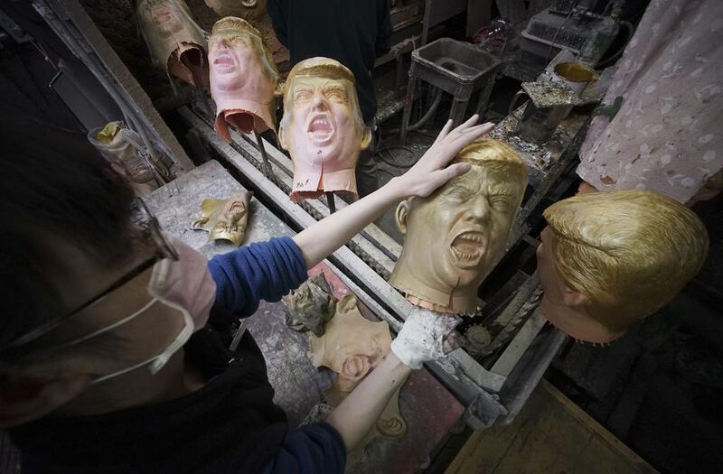 A worker moulds rubber masks depicting President-elect Donald Trump on a production line at the Ogawa Studio in Saitama, north of Tokyo. Ogawa Studio, the only manufacturer of rubber masks in Japan, is working non-stop to catch up with a flood of orders for Trump masks since his election victory one week ago. The 23 staff are trying to produce 350 likenesses of Trump a day, up from 45 before the US election, factory executive manager Takahiro Yagihara said. Eugene Hoshiko / AP Photo