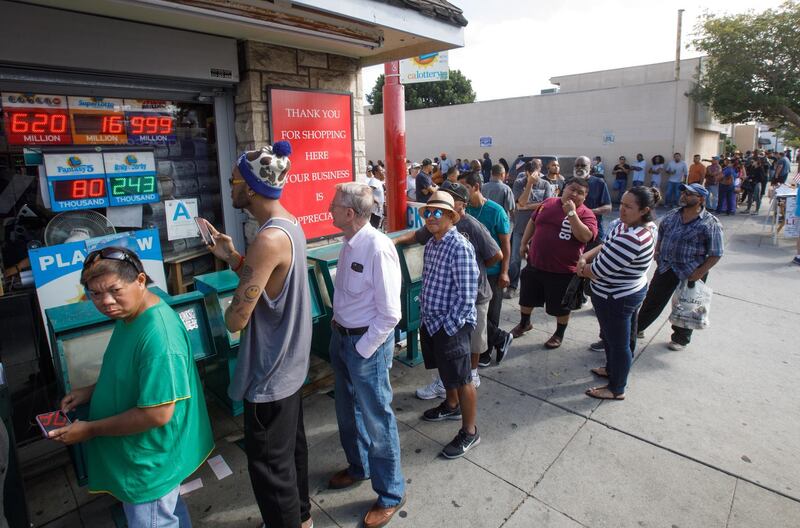 epaselect epa07114940 Hundreds of people line up to buy Mega Millions lottery tickets as the jackpot reached at least $1.6 billion outside the Bluebird Liquor store in Hawthorne, California, USA, 23 October 2018. The jackpot exceeded the store sign's ability to display more than a $999 million payout.  EPA/EUGENE GARCIA