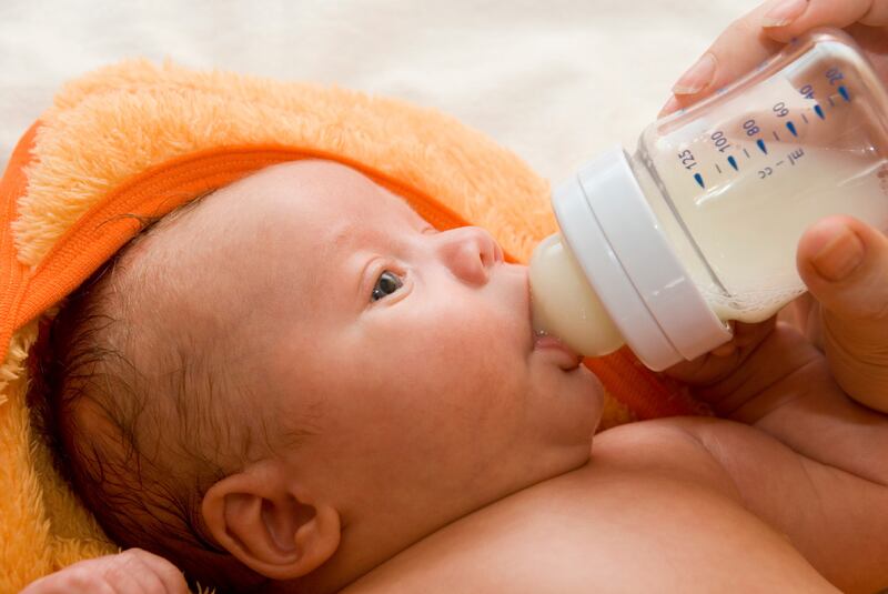 Mother give drink her baby boy by feeding bottle (iStockphoto.com)