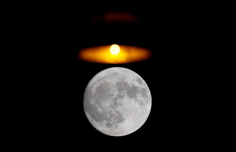 A street light is seen over the moon in downtown Rome, Italy. Reuters