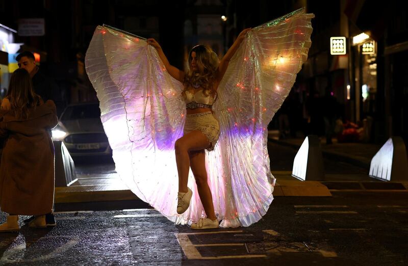 A woman dances in Soho. Reuters