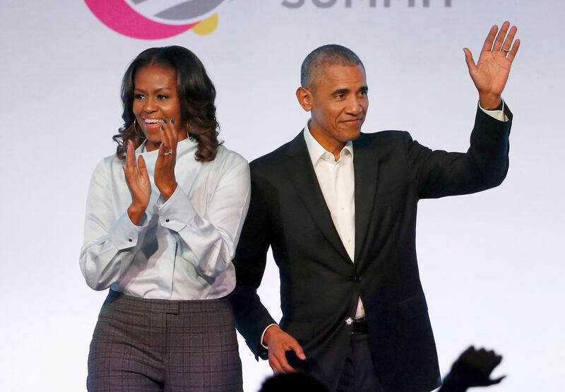 FILE - In this Oct. 31, 2017 file photo, former President Barack Obama, right, and former first lady Michelle Obama appear at the Obama Foundation Summit in Chicago. The couple's production company is teaming up with Spotify to produce exclusive podcasts for the platform. Under the Higher Ground partnership announced Thursday, June 6, 2019, the former president and first lady will develop and lend their voices to select podcasts on wide-ranging topics to connect with listeners around the world.   (AP Photo/Charles Rex Arbogast, File)