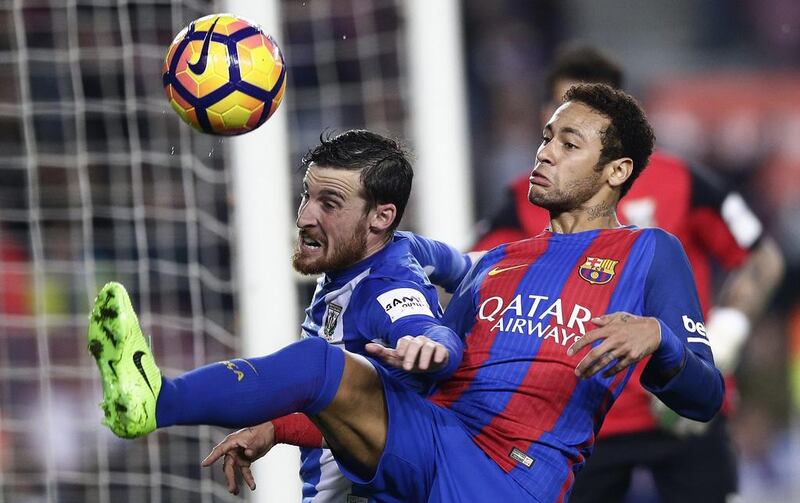 Barcelona’s Neymar, right, duels for the ball against Leganes’ Roberto Tito Roman. Manu Fernandez / AP Photo