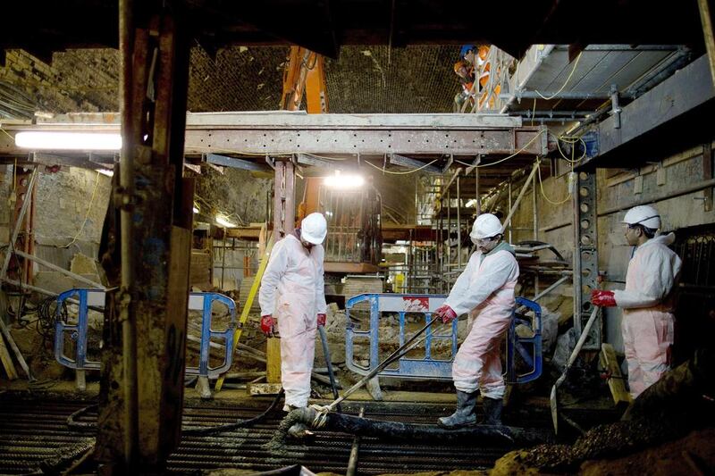 Workers pour concrete to form a strengthening slab inside the Connaught Tunnel, an old Victorian tunnel which is being brought back into use for the Crossrail project. Adrian Dennis / AFP