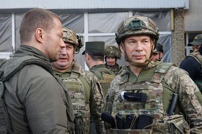 Ukraine's new army chief Сol Gen Oleksandr Syrskyi (right) meeting soldiers near the frontline with Russia. AFP