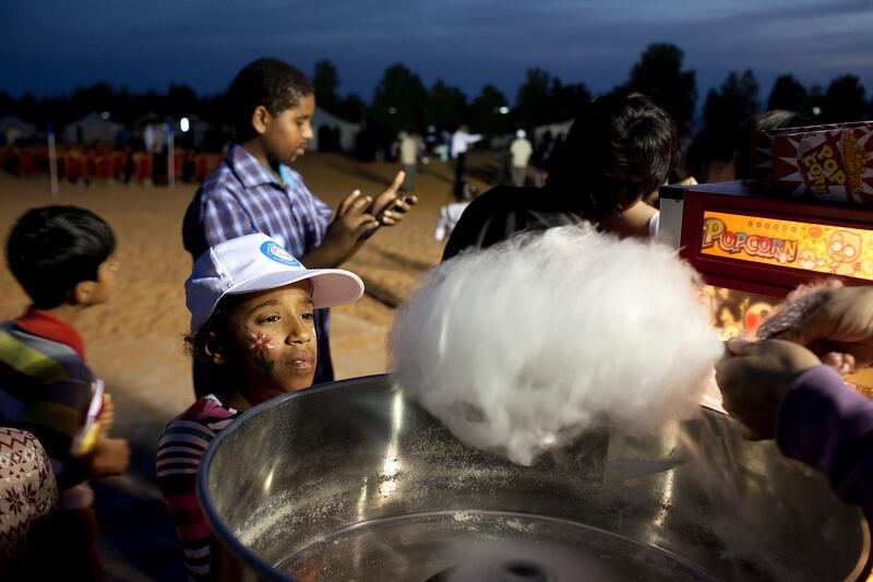 Al Ain, United Arab Emirates, January 30, 2013: 
Children anxiously await their cotton candy during a Family Day organized for the employees and the foster families of Dar Zayed for Family Care, a state-funded  programme in Al Ain for abandoned, orphaned or neglected children, on Wednesday evening, Jan. 30, 2013, at the Al Bedaa Resort near Al Ain where the organization is based. The children attending Family Day were a mixture of staff children, children who live in Dar Zayed villas and children placed long-term with outside foster families. It is the second time Dar Zayed has held the Family Day event.
Silvia Razgova / The National
