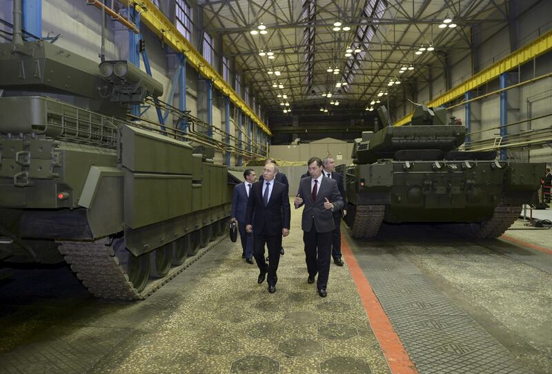 Russian President Vladimir Putin (L) listens to Andrei Terlikov, the head of the Ural Transport Machine Building Design Bureau, as they watch Russian infantry fighting vehicle with the Armata Universal Combat Platform and a T-14 Armata main battle tank at he Uralvagonzavod factory in the Urals city of Nizhny Tagil, Russia November 25, 2015. Speaking on a trip to the Ural mountains city of Nizhny Tagil, Putin ordered the despatch of an advanced weapons system to Russia's Khmeimim air base in Syria's Latakia province. REUTERS/Alexei Nikolskyi/Sputnik/Kremlin ATTENTION EDITORS - THIS IMAGE HAS BEEN SUPPLIED BY A THIRD PARTY. IT IS DISTRIBUTED, EXACTLY AS RECEIVED BY REUTERS, AS A SERVICE TO CLIENTS.      TPX IMAGES OF THE DAY      - GF20000073374