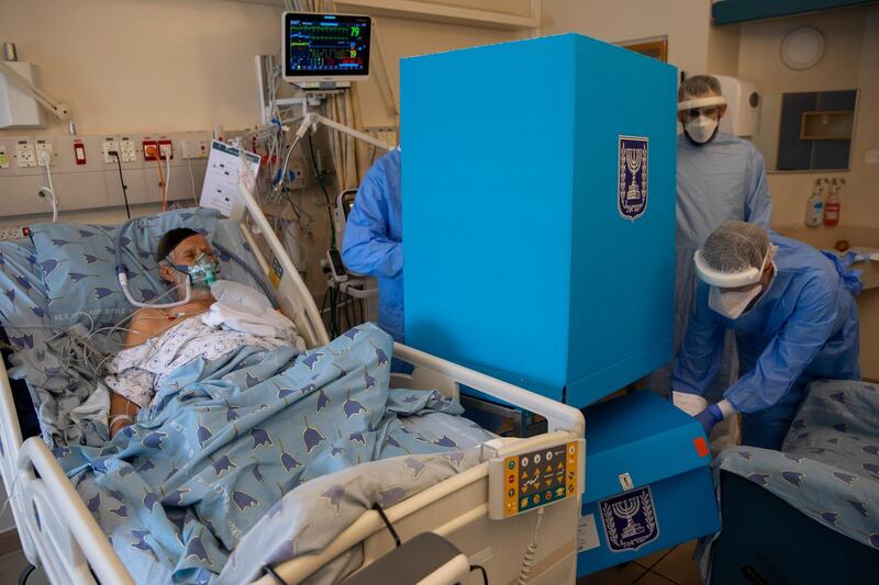 Covid-19 patient Rahamim Havura votes in Israel's parliamentary election inside an intensive care ward for coronavirus patients at Ichilov Hospital in Tel Aviv. AP