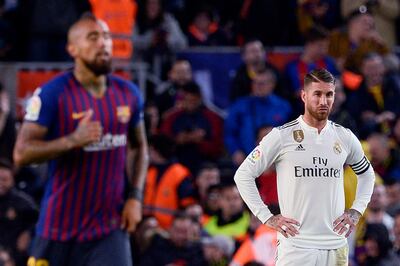 Real Madrid's Spanish defender Sergio Ramos (R) reacts to Barcelona's Chilean midfielder Arturo Vidal's goal during the Spanish league football match between FC Barcelona and Real Madrid CF at the Camp Nou stadium in Barcelona on October 28, 2018. / AFP / Josep LAGO
