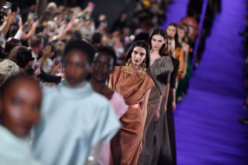 Amira Al Zuhair, in the centre wearing a satin bias-cut dress, on the Alexis Mabille runway. AFP