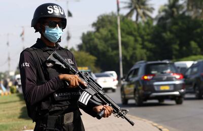 A Pakistani security official guards a roadside check point in Karachi in 2021. EPA