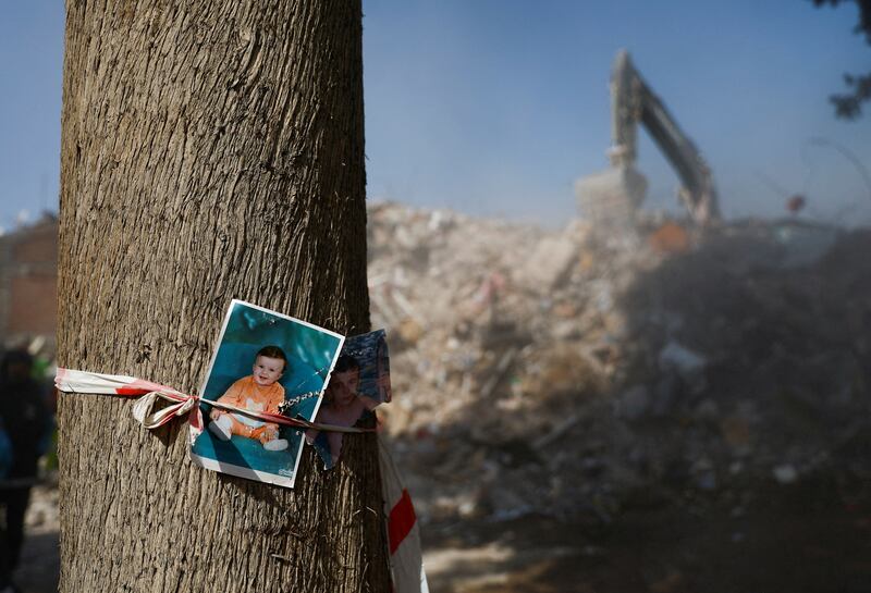 Photographs of missing children are fixed to a tree near rubble, in the aftermath of a deadly earthquake in Kahramanmaras, Turkey. Reuters