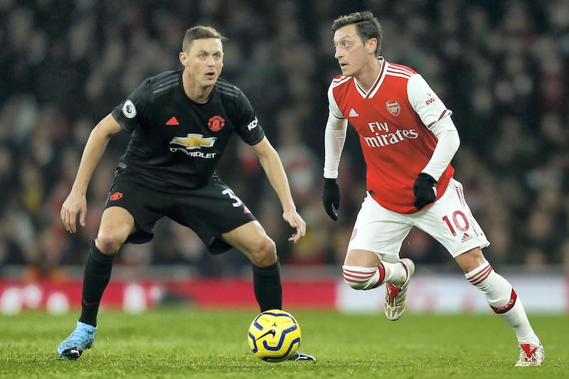 Arsenal's German midfielder Mesut Ozil (R) vies with Manchester United's Serbian midfielder Nemanja Matic (L) during the English Premier League football match between Arsenal and Manchester United at the Emirates Stadium in London on January 1, 2020. (Photo by Ian KINGTON / IKIMAGES / AFP) / RESTRICTED TO EDITORIAL USE. No use with unauthorized audio, video, data, fixture lists, club/league logos or 'live' services. Online in-match use limited to 45 images, no video emulation. No use in betting, games or single club/league/player publications.