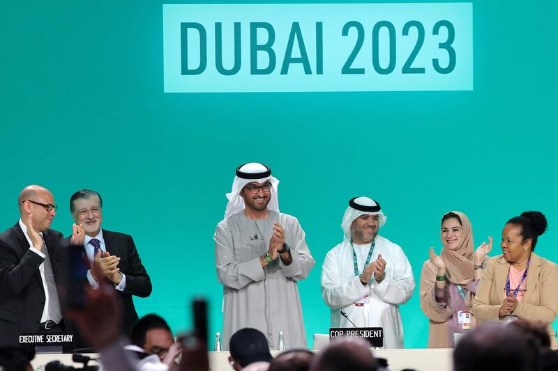 Cop28 President Dr Sultan Al Jaber applauds at the UN climate summit in Dubai on Wednesday where a deal was unanimously adopted. AFP
