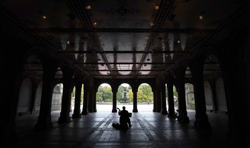 A man plays guitar under a empty Bethesda Terrace in Central Park in New York City. AFP