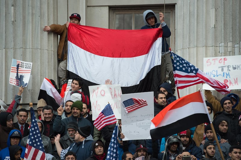 (FILES) In this file photo taken on February 2, 2017, people rally with flags at Brooklyn Borough Hall in new York as Yemeni bodega and grocery-stores shut down to protest US President Donald Trump's Executive Order banning immigrants and refugees from seven Muslim-majority countries, including Yemen.  Some 1,250 Yemenis were granted a reprieve from possible expulsion back to their war-torn country on July 5, 2018. Homeland Security Secretary Kirstjen Nielsen said the Yemenis, who had been permitted to remain in the US past the expiration of their visas due to the war in the Arabian Peninsula country, would be able to stay at least another 18 months, through March 3, 2020.
 / AFP / Bryan R. Smith
