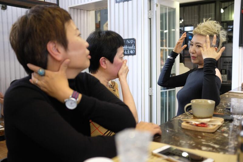 The 56-year-old Chinese model Ma Yinhong, right, talking to her friends at a cafe in central Shanghai. AFP