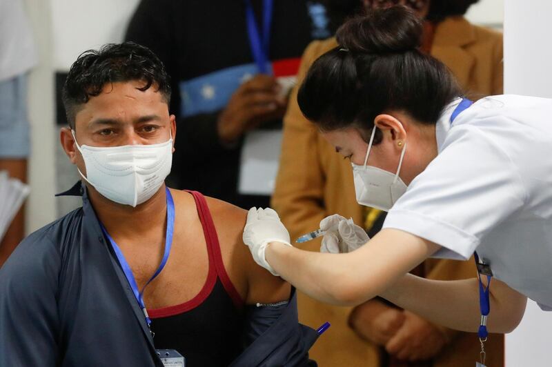 Sanitation worker Manish Kumar, who according to the officials is the first person in India to be vaccinated against Covid-19, receives a dose of Bharat Biotech's Covaxin vaccines at the All India Institute of Medical Sciences (AIIMS) hospital in New Delhi. Reuters