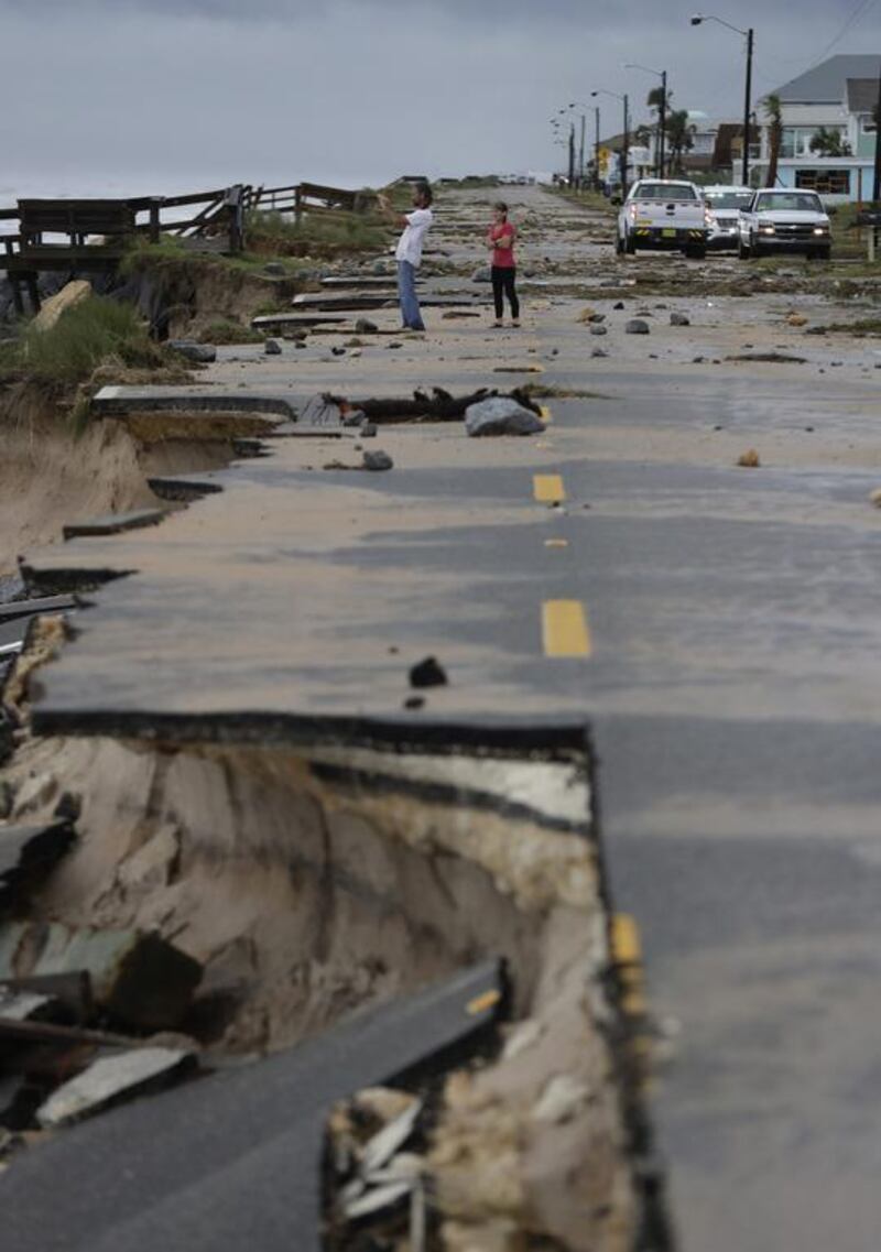 Onlookers take photos at Highway A1A after it was partially washed away by Hurricane Matthew in Flagler Beach, Florida. Eric Gay / AP Photo