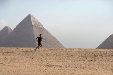 epa08236999 A participant runs near the Giza Pyramids during a race of the Pyramids Half Marathon at the Giza Plateau, Giza, Egypt, 22 February 2020. Runners from around the world participated in the Pyramids Half Marathon near the Great Pyramids of Giza which included three races of six, ten and 21 kilometers. EPA/MOHAMED HOSSAM