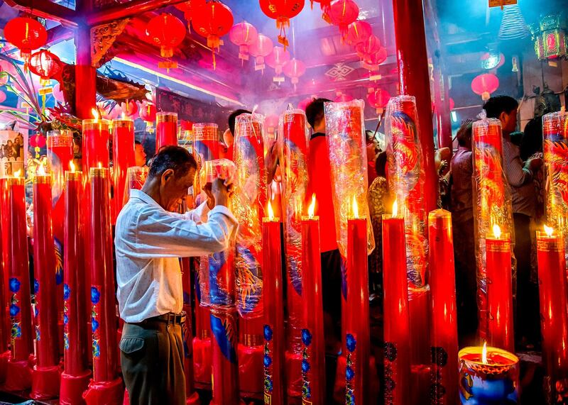 A Chinese-Indonesian man prays on the eve of the Lunar New Year in Surabaya, East Java province. Juni Kriswanto / AFP Photo