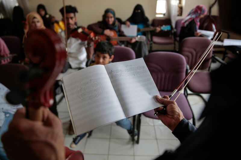 Abdullah El-Deb'y teaches his students during a music class at the Cultural Centre in Sanaa, Yemen. Hani Mohammed / AP Photo