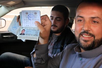 epa07094846 People show their stamped passports at Jaber-Nassib border crossing after it was reopened between Syria and Jordan, 15 October 2018. The Nassib-Jaber border crossing between Syria and Jordan was reopened on 15 October for commercial traffic after three years of inactivity, as the Syrian side of the border was controlled by militants up until July, according to the state-run Syrian and Jordanian news services.  EPA/STRINGER