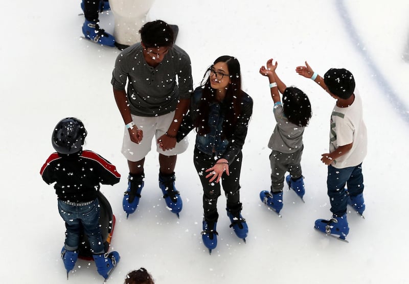 Dubai, United Arab Emirates - June 30th, 2018: Visitors ice skate with snowfall sessions. Saturday, June 30th, 2018 in Dubai Mall, Dubai. Chris Whiteoak / The National