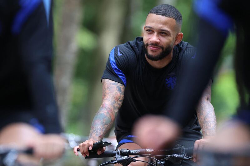 Netherlands forward Memphis Depay rides a bike after a training session in Zeist ahead of the Euro 2020 Group C match against North Macedonia. AFP