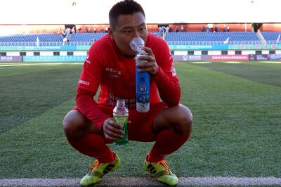 This photo taken on September 24, 2017 shows a player of Zibo Sunday using an oxygen tank during their 2017 Chinese Football Association Amateur League football match against Lhasa Chengtou at the People's Cultural and Sports Center, located at a height of 3,658 metres (12,000 feet) above sea level, in Lhasa in China's western Tibet Autonomous Region.
There will be mid-game oxygen breaks but no team will fancy a trip to sky-high Lhasa Chengtou next season after they made history in becoming the first Tibetan side to reach China's professional league. / AFP PHOTO / STR / China OUT / TO GO WITH AFP STORY FBL-ASIA-CHN-TIBET-MINORITIES,FOCUS BY PETER STEBBINGS