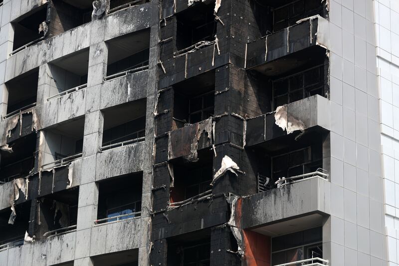 The blackened exterior of the damaged building. Chris Whiteoak / The National