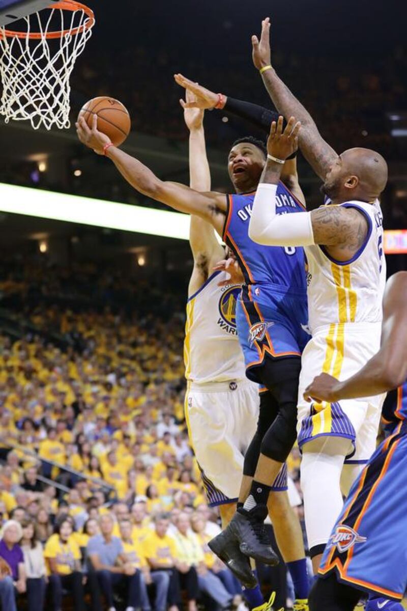 Russell Westbrook #0 of the Oklahoma City Thunder goes up for a shot against Marreese Speights #5 of the Golden State Warriors in Game Seven of the Western Conference Finals during the 2016 NBA Playoffs at ORACLE Arena on May 30, 2016 in Oakland, California. Ezra Shaw/Getty Images/AFP
