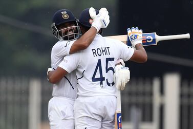 Rohit Sharma (R) celebrates his century with team-mate Ajinkya Rahane during the first day of the third and final Test match between India and South Africa. AFP