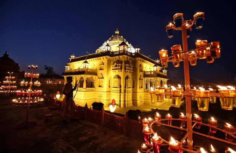 A policeman stands guard in front of the illuminated Akshardham temple on the eve of Diwali, the Hindu festival of lights, in Gandhinagar, India, November 6, 2018. REUTERS/Amit Dave