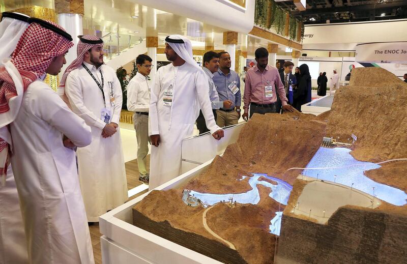 DUBAI , UNITED ARAB EMIRATES ,  October 23 , 2018 :- Visitors looking at the model of Hydroelectric Power Station Project in Hatta at the DEWA stand during the WETEX 2018 held at Dubai World Trade Centre in Dubai. ( Pawan Singh / The National )  For News/Business. Story by Patrick/ Jennifer