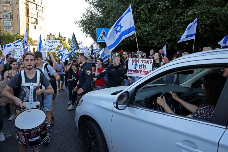 Protesters blocked roads across Israel, hours after parliament adopted a key clause of the government's judicial overhaul package, which opponents say threatens democracy. AFP