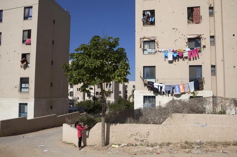 A young Palestinian girl nearby buildings in  Sheik Zayed City which have been damaged during Israeli military attacks. Heidi Levine for The National