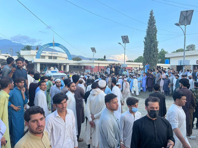 Locals gather outside a hospital after the blast in Bajaur. EPA