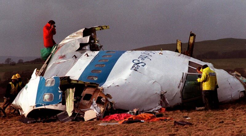 FILE - In this Dec 22, 1988 file photo police and investigators look at what remains of the flight deck of Pan Am 103 in a field in Lockerbie, Scotland. In 1988, 270 people were killed when a terrorist bomb exploded aboard a Pam Am Boeing 747 over Lockerbie, Scotland, sending wreckage crashing to the ground. (AP Photo/File)